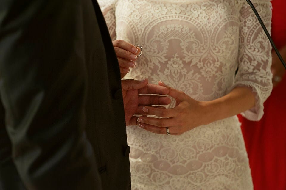 Ring exchange detail at Iglesia de Piedra Ensenada wedding ceremony