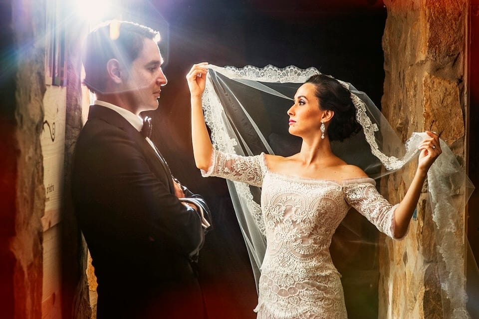 Newlywed couple walking through Casa de Piedra vineyard after ceremony