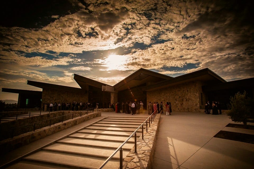 Wedding reception at Museo de la Vid y el Vino — panoramic Valle de Guadalupe view through glass