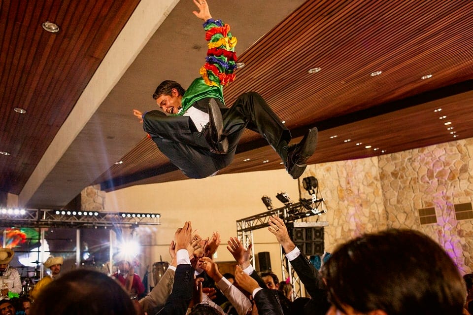Groom mid-jump in celebration at Ruta del Vino wedding reception