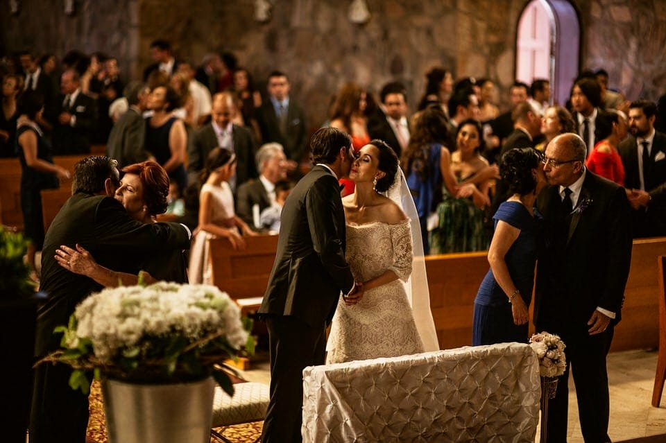 Bride and groom exchanging vows at Iglesia de Piedra Ensenada