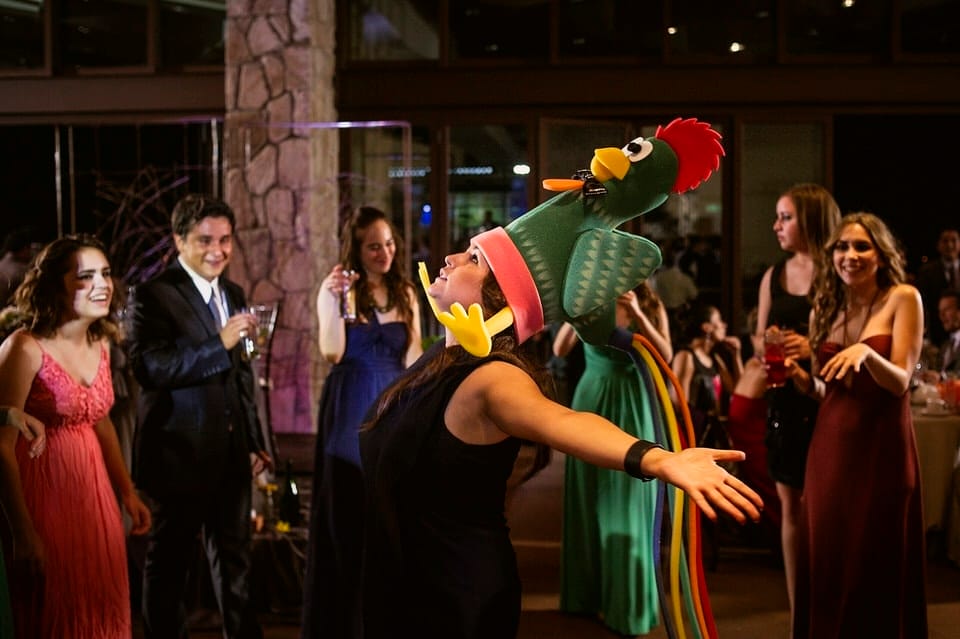 Guest with decorative bird hat at Ensenada wedding reception