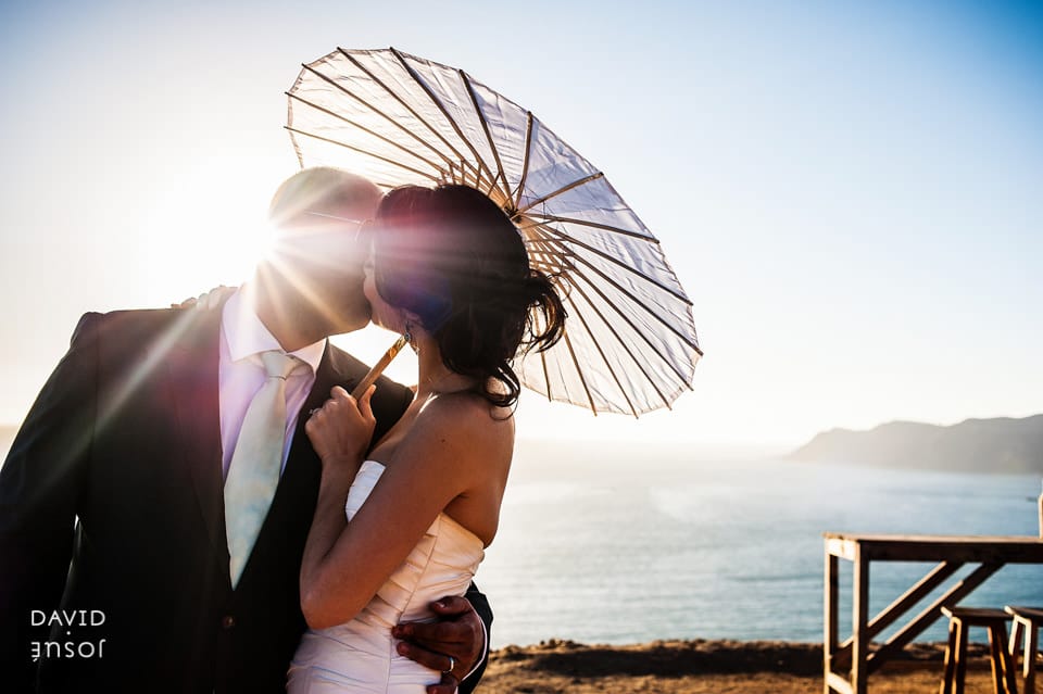 morning — soft light through coastal haze for getting-ready frames | ceremony — beachfront positioning with the Pacific as backdrop | couple portraits at golden hour — sand, surf line, sunset over the water