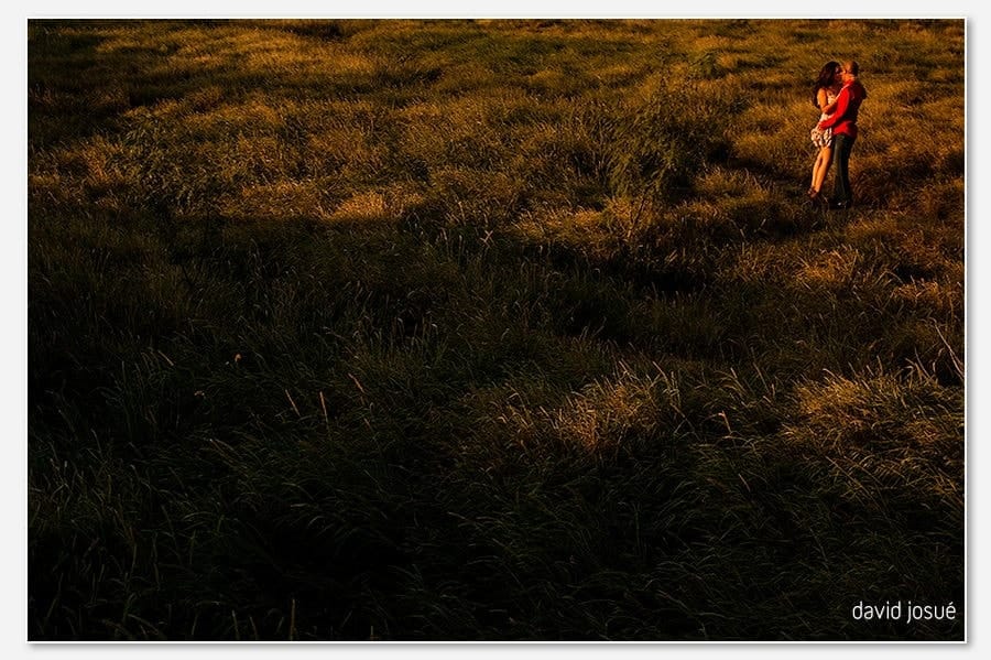 two-body chemistry — the camera reads gestures, glances, and physical closeness between the couple | location-specific framing — the chosen setting reads as part of the photograph, not just backdrop | warm working-hour light wraps both bodies cleanly when the timing is right