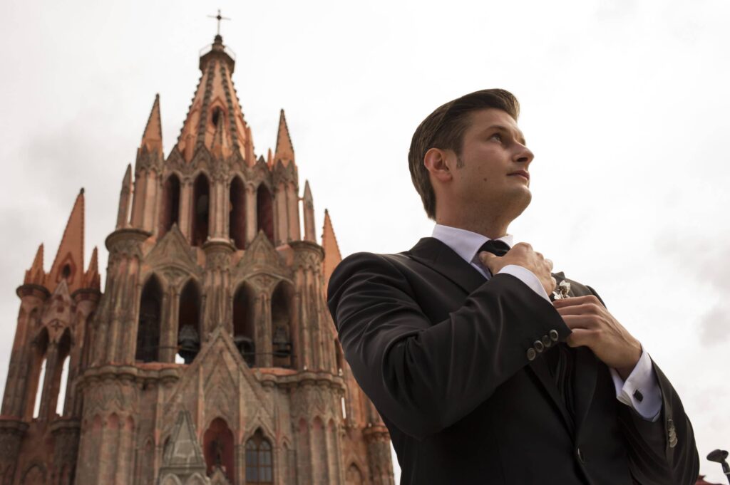 warm cantera and adobe surfaces hold the day's heat and read warm in late-afternoon light | rooftop terraces with parroquia views — the pink neo-gothic church facade is one of the city's signature backdrops | interior courtyards in colonial haciendas give cloister geometry for couple portraits