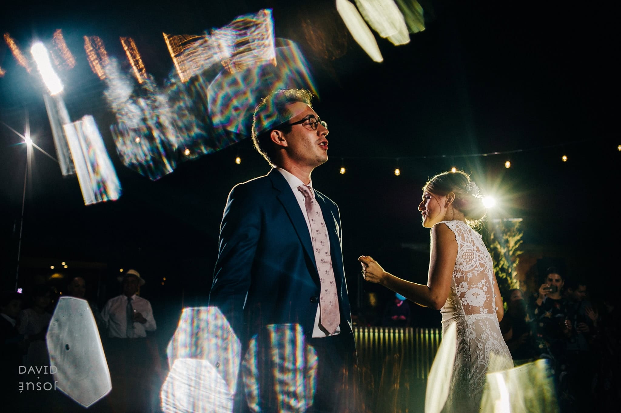 modern, low-profile architecture sets clean rectilinear backdrops behind couple portraits | interior surfaces and natural materials photograph honestly without color correction | the surrounding vineyards give the photographer receding-line geometry during the final golden hour