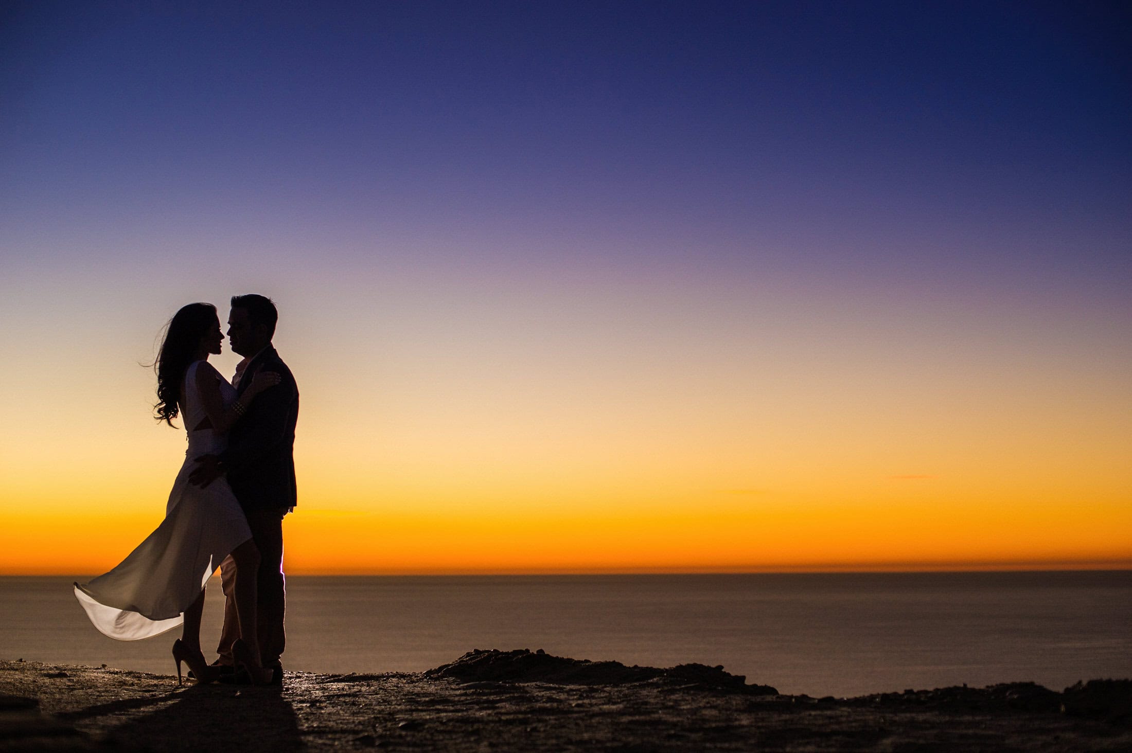 morning — soft, indirect light if getting-ready happens on property | ceremony — cliff-edge positioning gives broad open backdrop | couple portraits at the final golden hour — vineyard side for receding lines, cliff-edge side for open sky