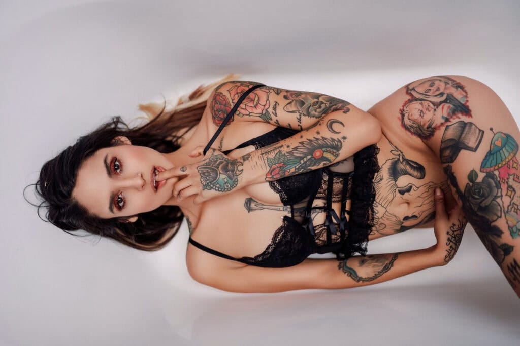 boudoir is intimate portraiture in a controlled environment, lit for skin and gesture | the photograph documents presence — quiet confidence, the body at rest, not a performance | the camera works the room's natural light, not theatrical lighting setups