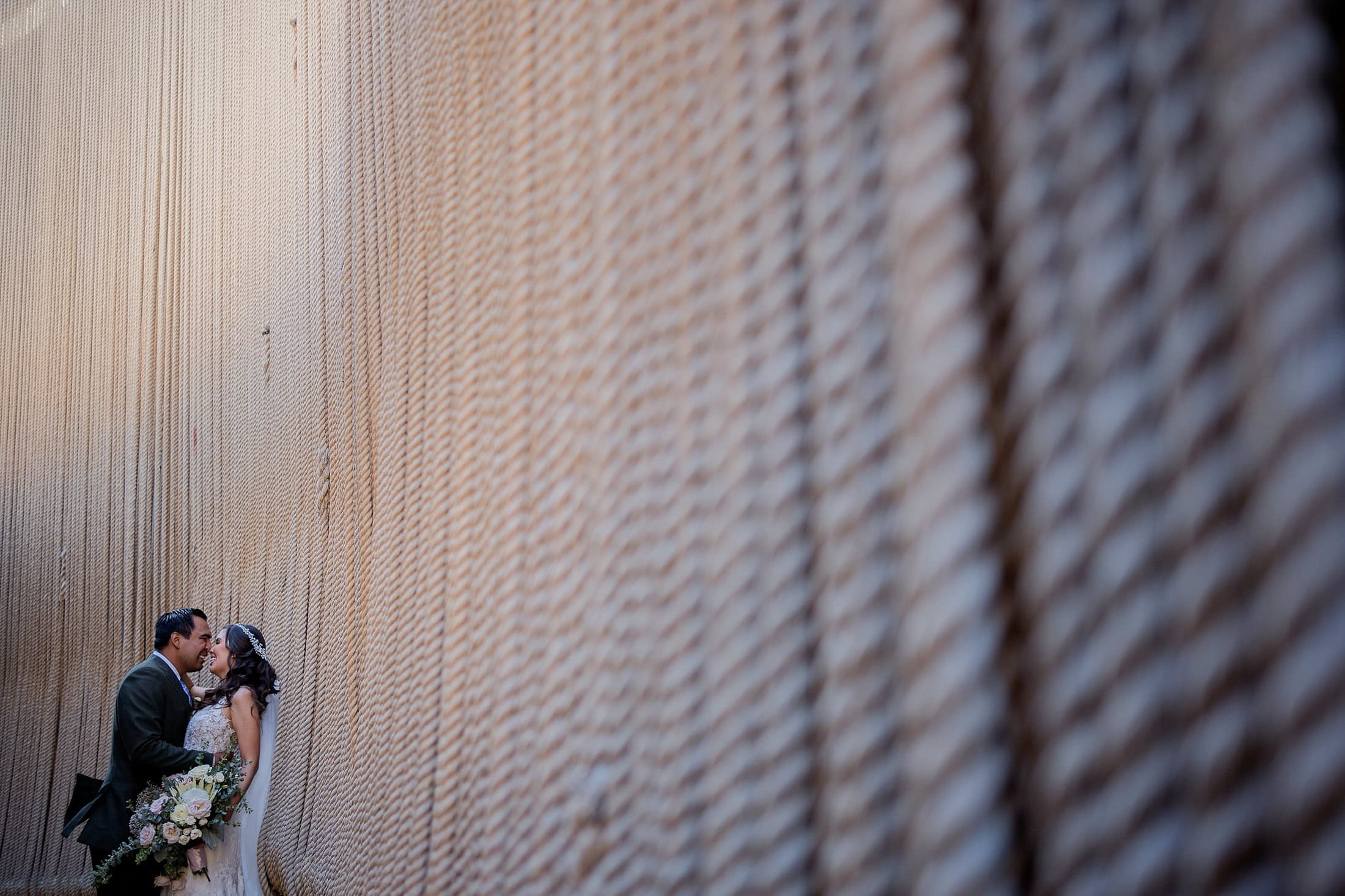 working vineyards on the property's grounds deliver receding-line geometry during golden hour | architectural character — warmer surfaces that read honest under tungsten and natural light | interior wine production spaces offer alternative environments for ceremony or reception