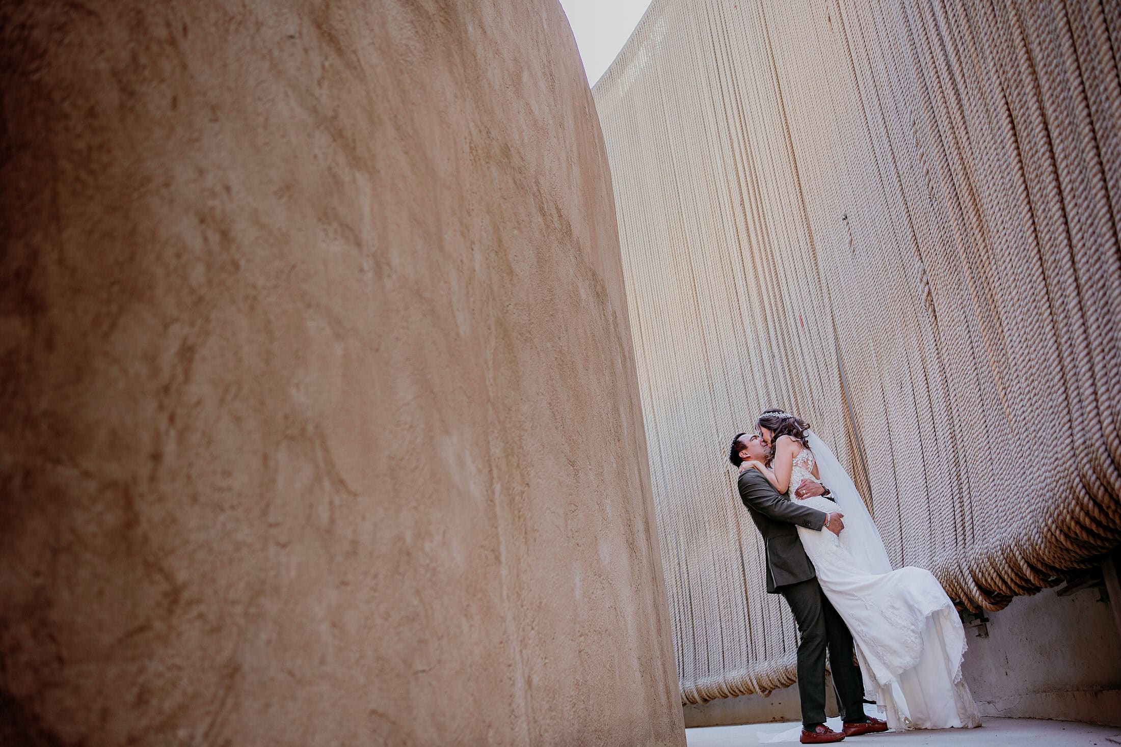 Intimate couple embrace at Monte Xanic winery — Valle de Guadalupe elopement photography by David Josué