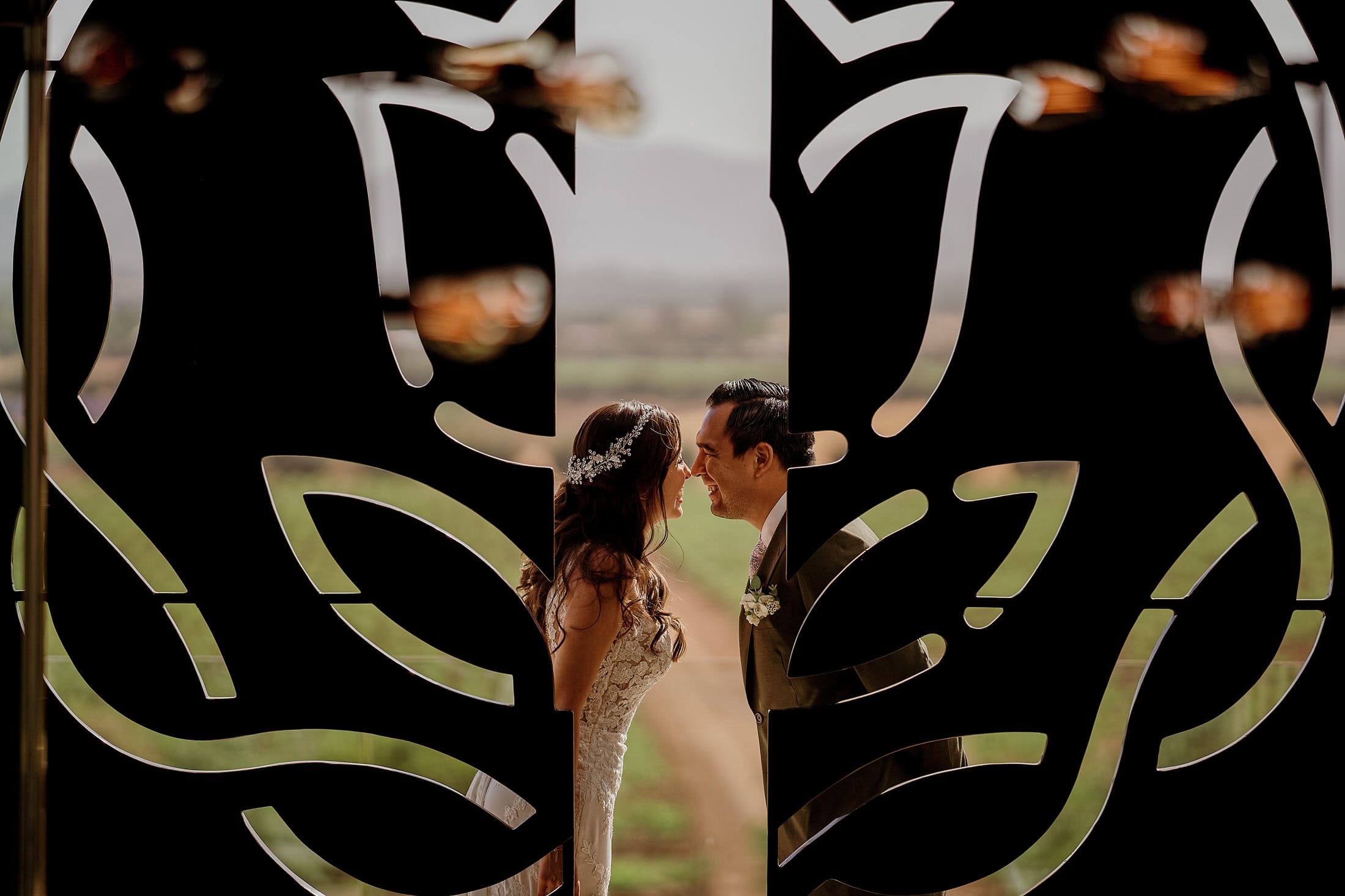 Wedding couple framed by art at Monte Xanic, Valle de Guadalupe