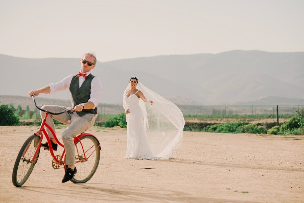 Bride and groom on a bicycle at Corona del Valle