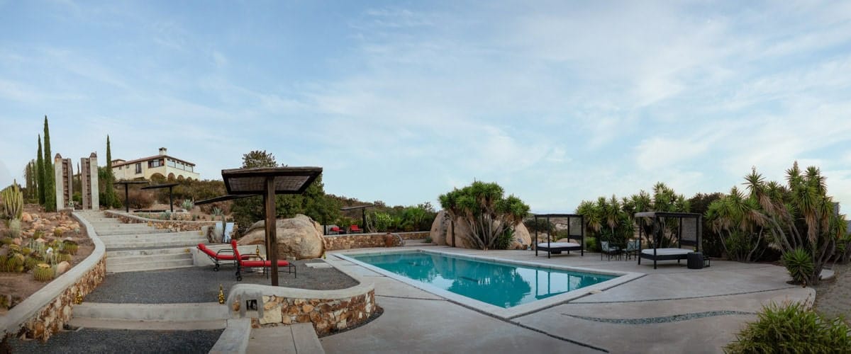 boutique resort architecture — warmer surfaces against working vineyards | on-site restaurant and lodging support multi-day wedding celebrations | vineyard surroundings deliver receding-line geometry during golden hour