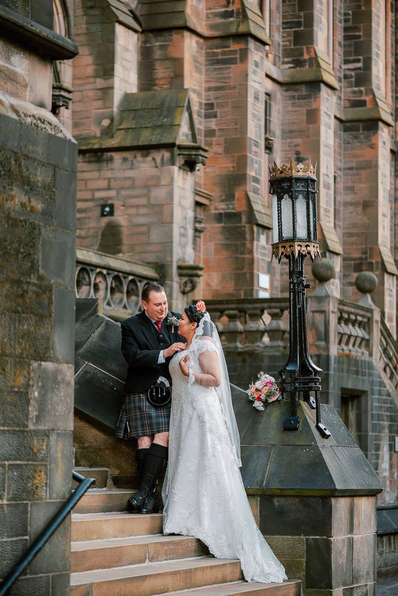 Bride and groom on the steps of St Mungo's Cathedral, Glasgow